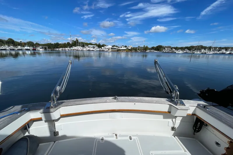 Slide: The Image of 1997 Little Harbor WhisperJet 36 boat deck with scenic marina view under blue sky. - 18
