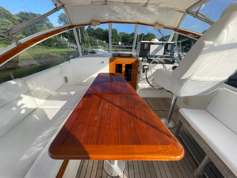 Slide: The Image of Interior of 1997 Little Harbor WhisperJet 36 with wooden table and white seating. - 3