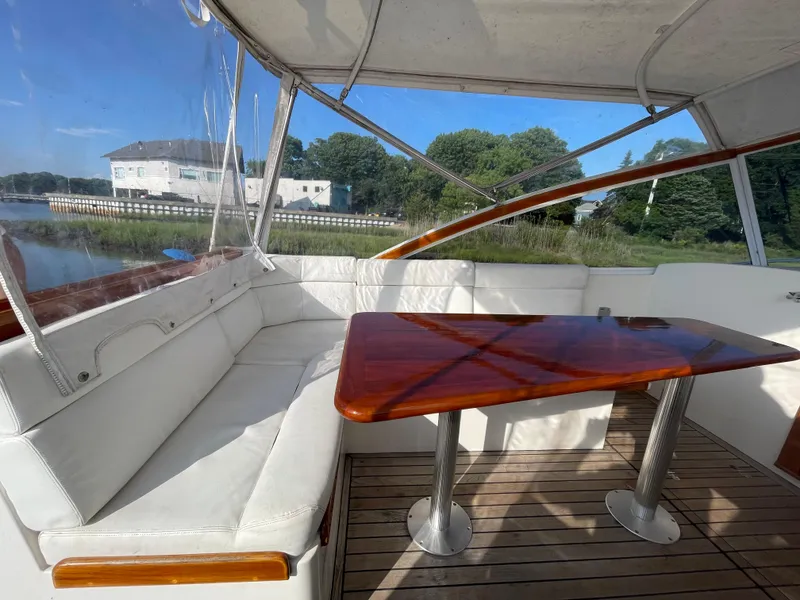 Slide: The Image of Interior of 1997 Little Harbor WhisperJet 36 with white seating and wooden table. - 5