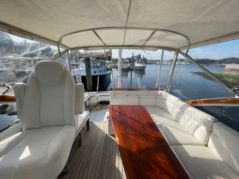 Slide: The Image of Interior of 1997 Little Harbor WhisperJet 36 yacht with white seating and wooden table. - 6