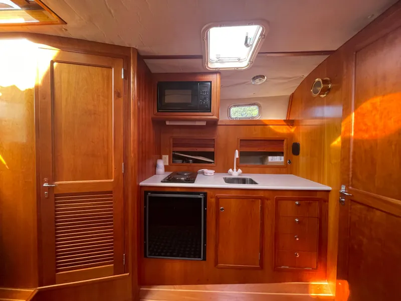 Slide: The Image of Interior of 1997 Little Harbor WhisperJet 36 yacht with wooden cabinetry and compact kitchen. - 8