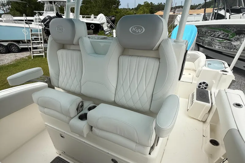 Slide: The Image of Luxurious seating on 2024 Key West 291 FS boat, featuring plush white upholstery and armrests. - 12