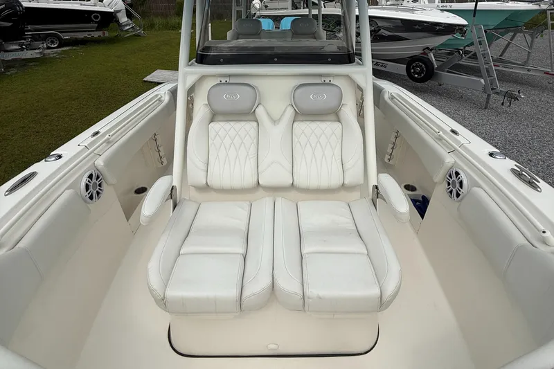 Slide: The Image of 2024 Key West 291 FS boat interior with white cushioned seating and modern design. - 15