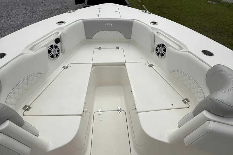 Slide: The Image of 2024 Key West 291 FS boat interior with white seating and speakers. - 16