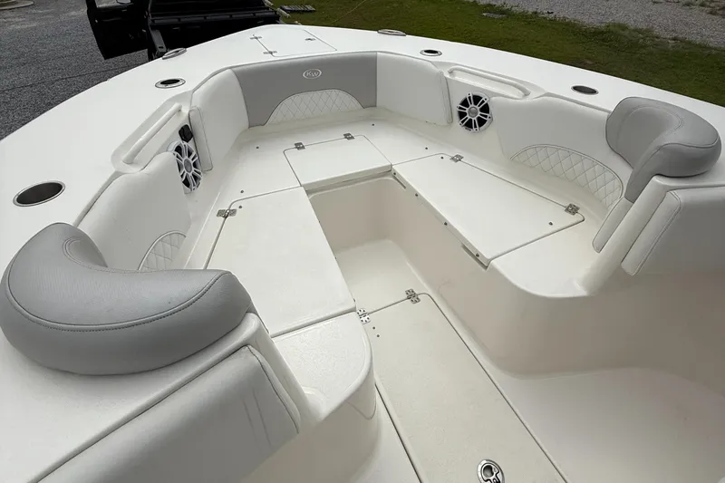 Slide: The Image of 2024 Key West 291 FS boat interior with cushioned seating and storage compartments. - 17