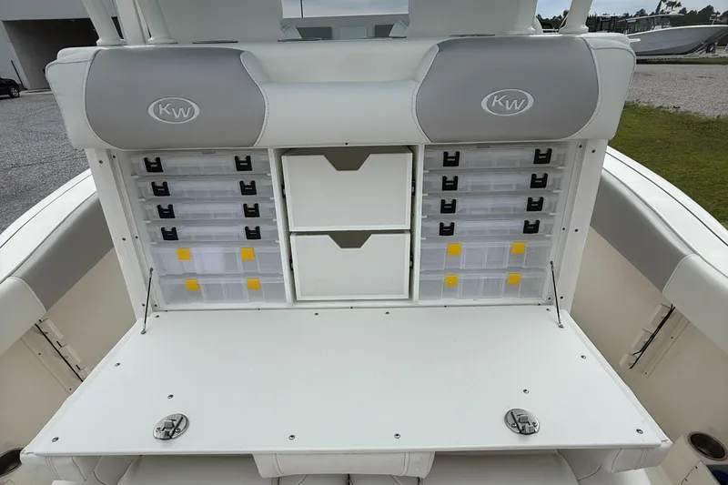 Slide: The Image of 2024 Key West 291 FS boat storage area with organized compartments and cushioned seating. - 20