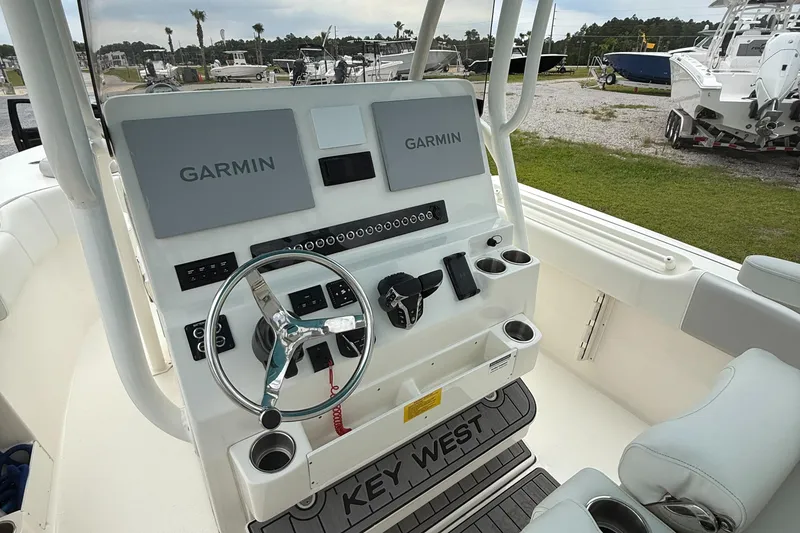 Slide: The Image of 2024 Key West 291 FS boat dashboard with dual Garmin displays and steering wheel. - 21