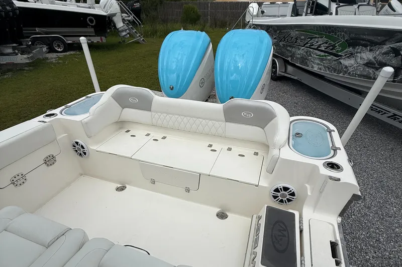 Slide: The Image of 2024 Key West 291 FS boat with twin blue engines and spacious seating area. - 22