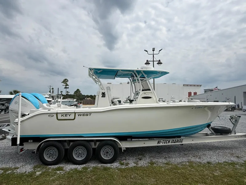 Slide: The Image of 2024 Key West 291 FS boat on trailer, outdoor display, cloudy sky background. - 4