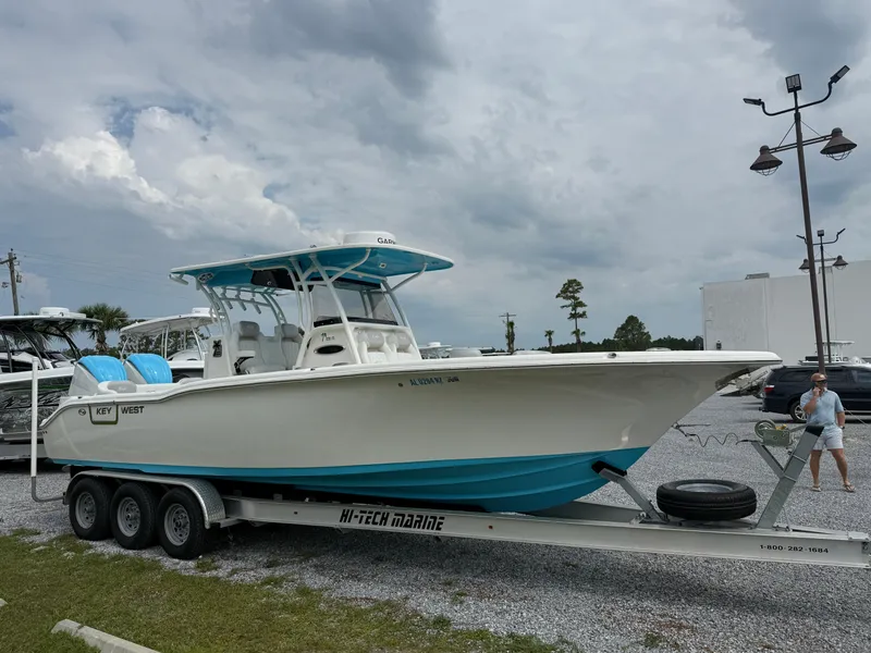Slide: The Image of 2024 Key West 291 FS boat on trailer, white and blue design, parked outdoors. - 5