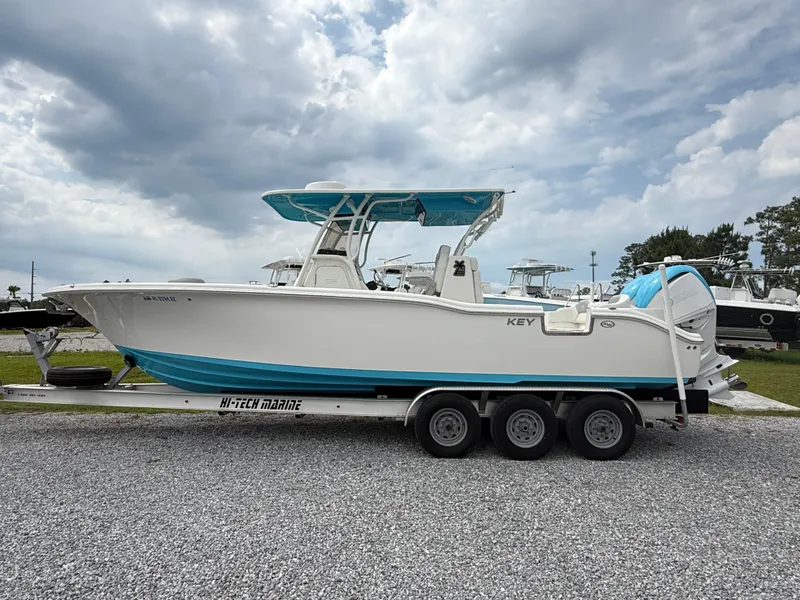Slide: The Image of 2024 Key West 291 FS boat on trailer, under cloudy sky. - 6