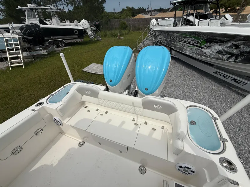 Slide: The Image of 2024 Key West 291 FS boat with dual blue outboard motors, spacious seating, and modern design. - 7