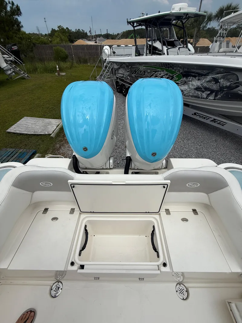 Slide: The Image of 2024 Key West 291 FS boat with dual blue outboard engines, docked outdoors. - 8