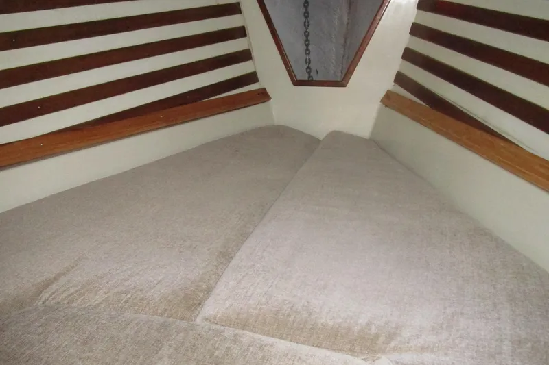 Slide: The Image of Interior cabin of a 1974 Irwin Competition 30 sailboat, featuring a cozy V-berth. - 12