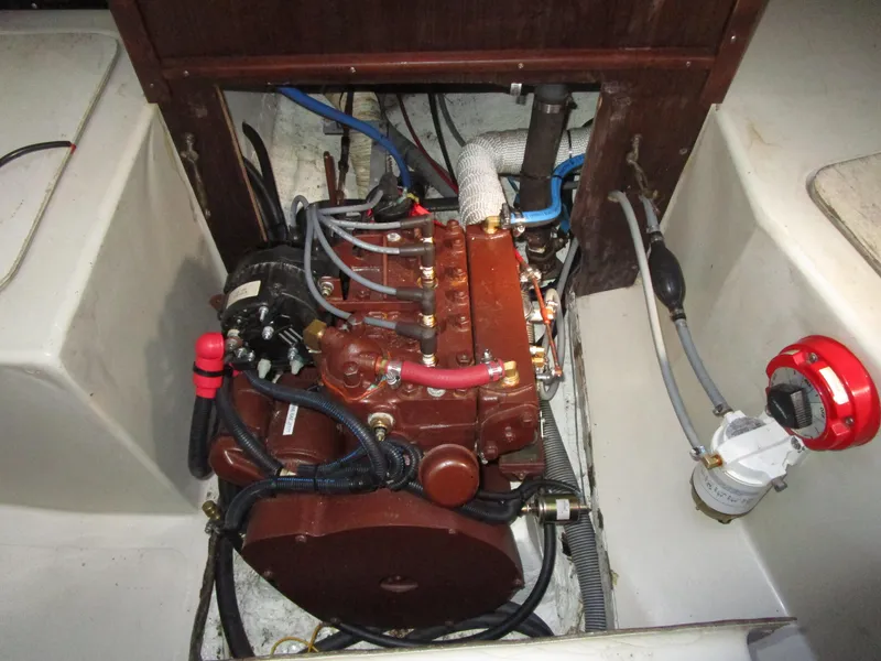 Slide: The Image of Engine compartment of a 1974 Irwin Competition 30 sailboat, showcasing detailed mechanical components. - 16