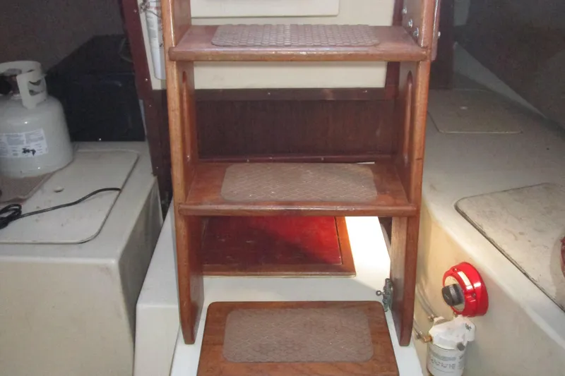 Slide: The Image of 1974 Irwin Competition 30 interior with wooden steps and propane tank. - 17