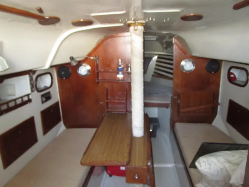 Slide: The Image of 1974 Irwin Competition 30 sailboat interior with wooden furnishings and cozy seating. - 18