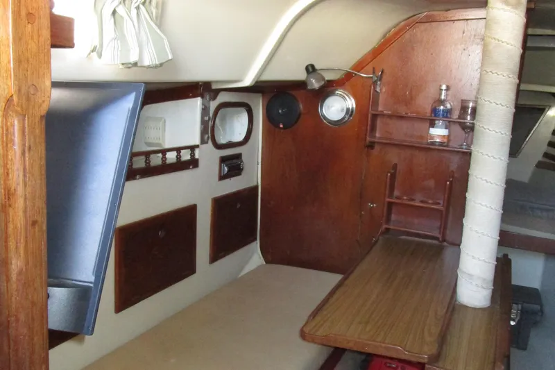 Slide: The Image of Interior of a 1974 Irwin Competition 30 sailboat, featuring wooden furnishings and compact design. - 8