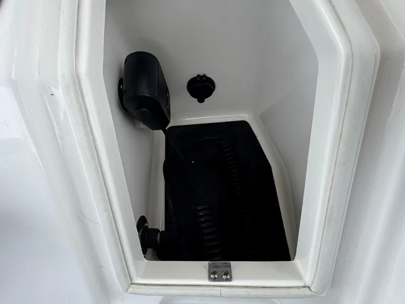 Slide: The Image of Storage compartment of a 2019 Regulator 31 boat, featuring a clean, white interior. - 13
