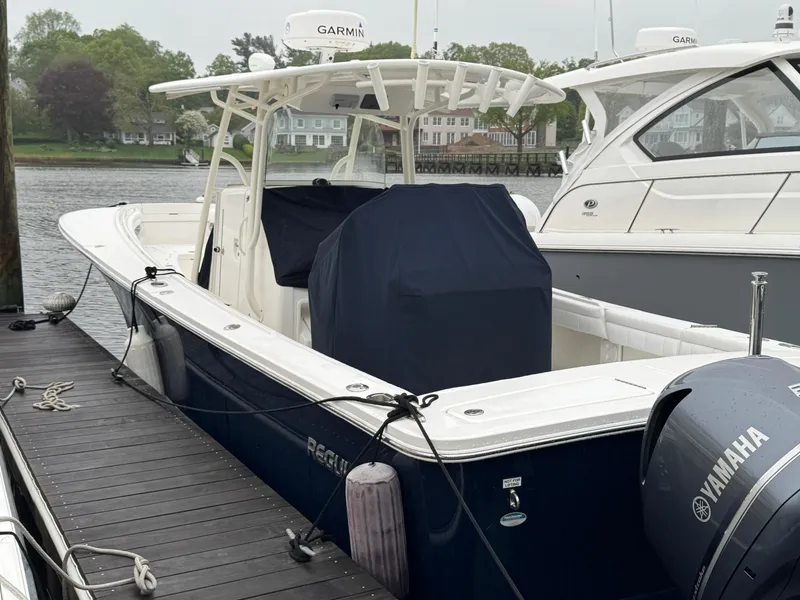 Slide: The Image of 2019 Regulator 31 boat docked, featuring Yamaha engine and Garmin equipment. - 2