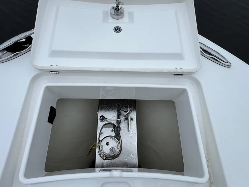 Slide: The Image of Open storage compartment on 2019 Regulator 31 boat, featuring anchor and latch. - 20