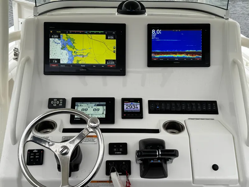 Slide: The Image of 2019 Regulator 31 boat dashboard with navigation screens and controls. - 7