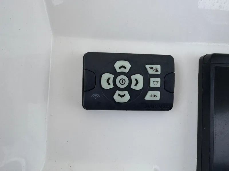 Slide: The Image of Control panel on a 2019 Regulator 31 boat with directional and SOS buttons. - 9