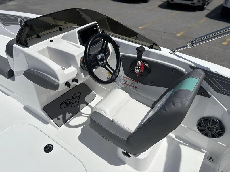 Slide: The Image of 2025 Tahoe T21 boat cockpit with steering wheel, control panel, and seating. - 14