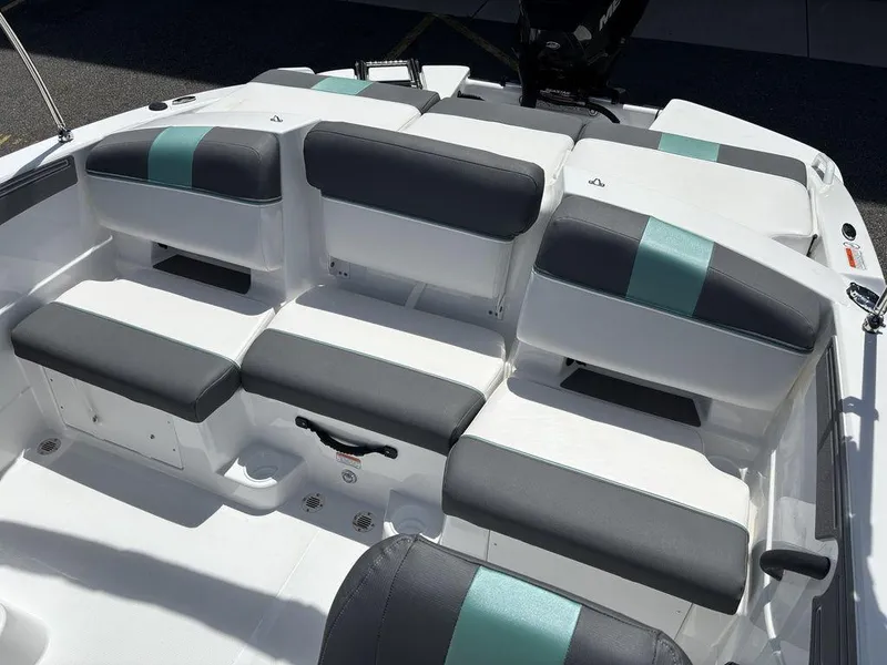 Slide: The Image of 2025 Tahoe T21 boat interior with gray and teal cushioned seating. - 19