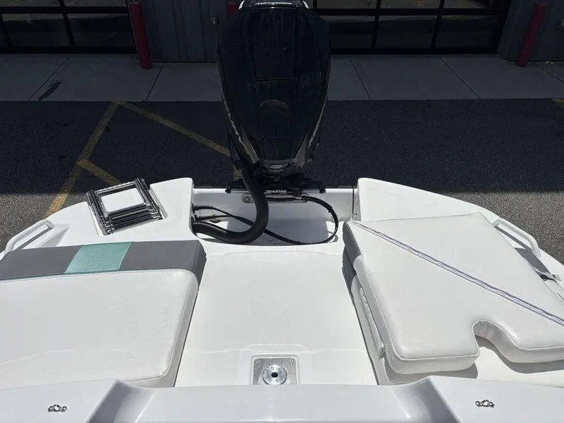 Slide: The Image of 2025 Tahoe T21 boat with sleek white deck and powerful outboard motor. - 22