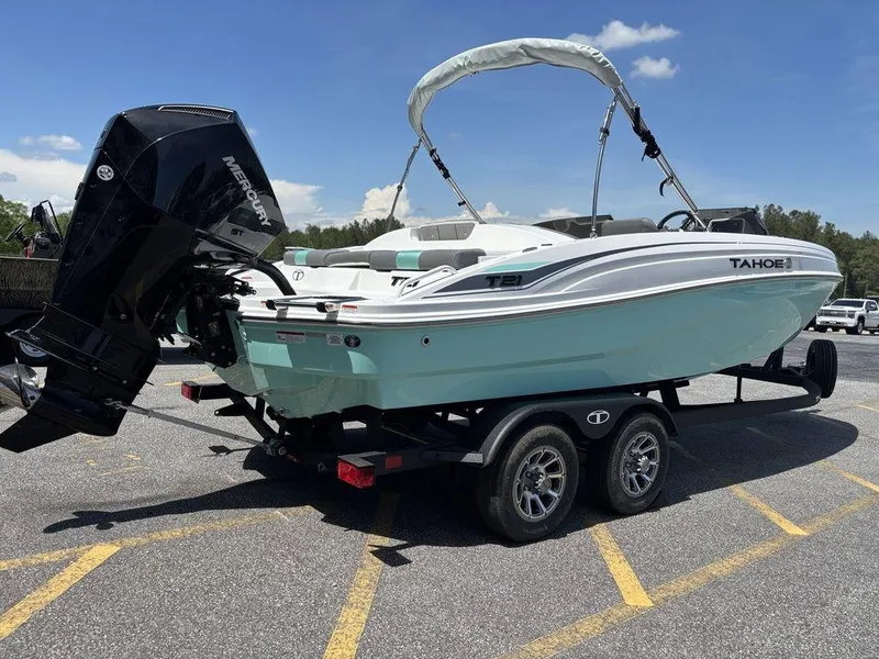 Slide: The Image of 2025 Tahoe T21 boat on trailer with outboard motor, parked in sunny lot. - 3