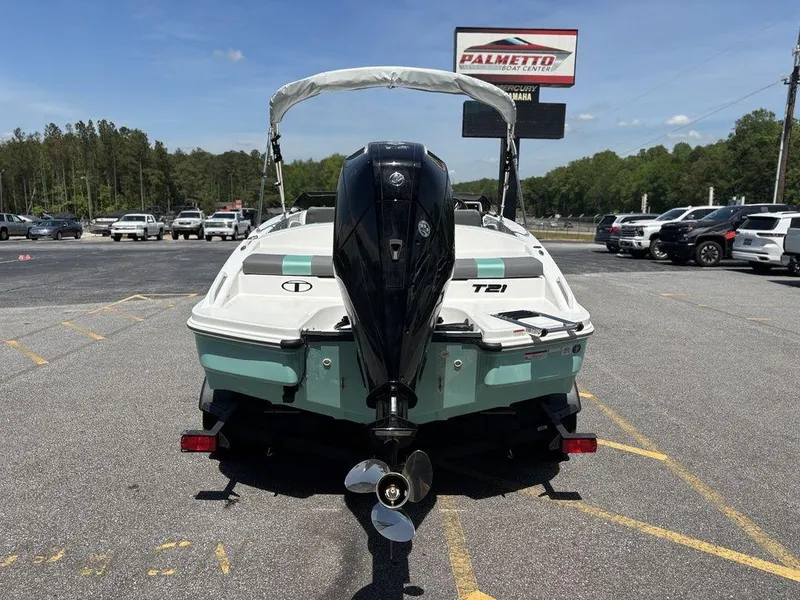 Slide: The Image of 2025 Tahoe T21 boat with outboard motor in parking lot, sunny day. - 4