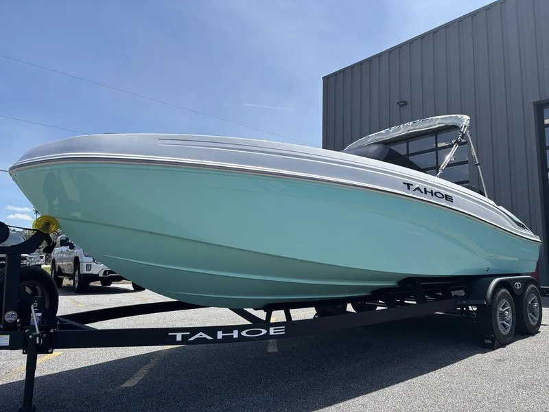 Slide: The Image of 2025 Tahoe T21 boat on trailer, light blue hull, parked outdoors. - 7