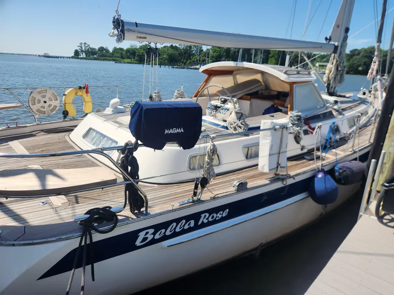Slide: The Image of 2006 Hallberg-Rassy 48 sailboat "Bella Rose" docked by the water on a sunny day. - 11