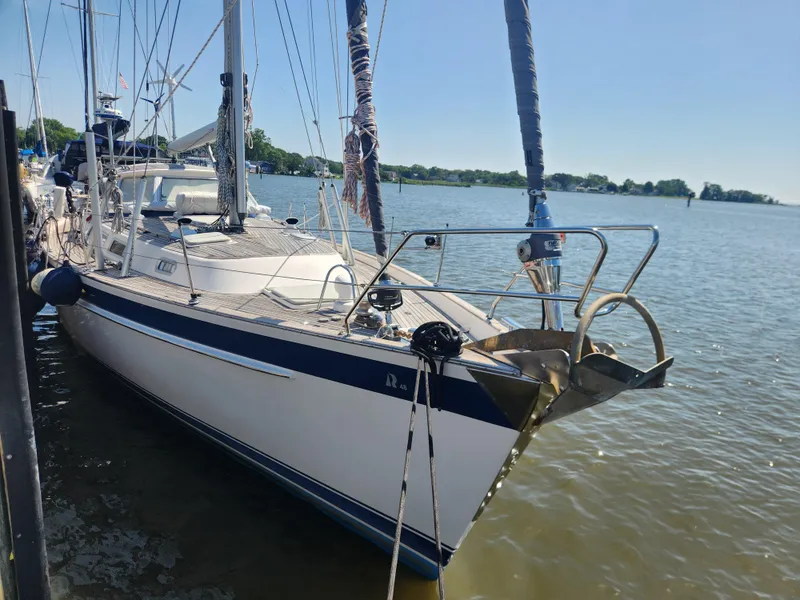 Slide: The Image of 2006 Hallberg-Rassy 48 sailboat docked on a sunny day, showcasing sleek design and craftsmanship. - 13