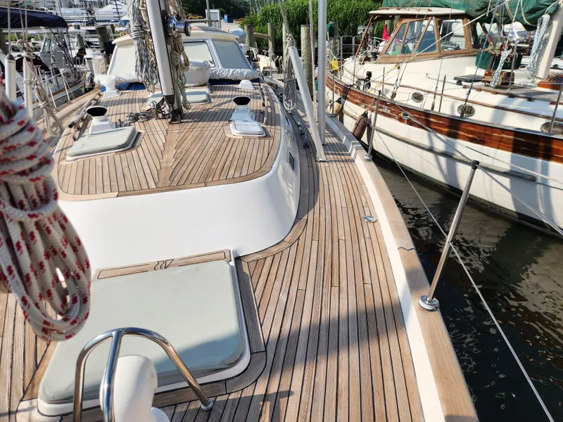 Slide: The Image of Deck view of a 2006 Hallberg-Rassy 48 yacht docked at a marina. - 14
