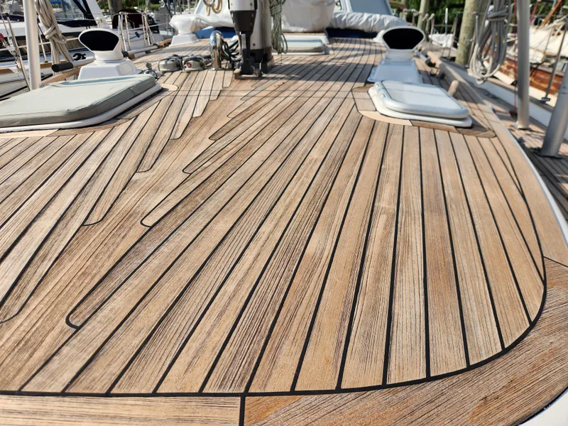 Slide: The Image of Teak deck of 2006 Hallberg-Rassy 48 sailboat, showcasing elegant wood craftsmanship. - 17