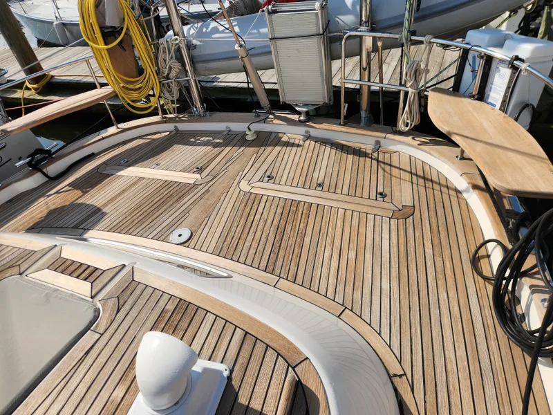 Slide: The Image of Teak deck of 2006 Hallberg-Rassy 48 sailboat, featuring clean lines and nautical equipment. - 21