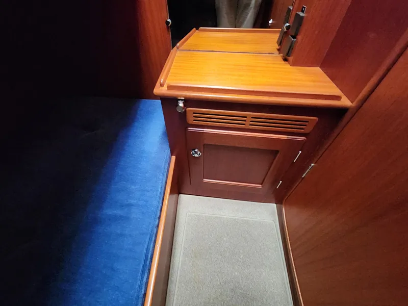 Slide: The Image of Interior of 2006 Hallberg-Rassy 48 yacht with wooden cabinetry and blue upholstery. - 33