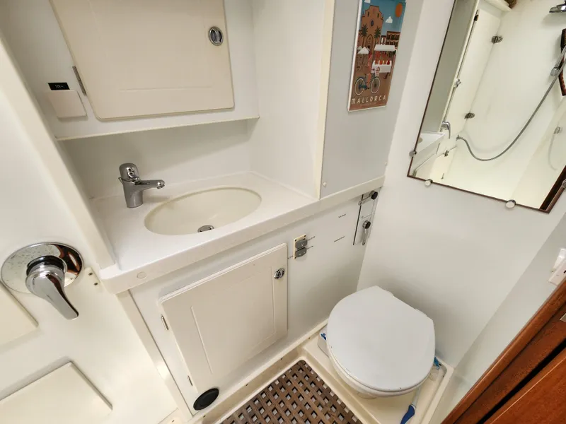 Slide: The Image of Bathroom interior of 2006 Hallberg-Rassy 48 yacht, featuring sink and toilet. - 34