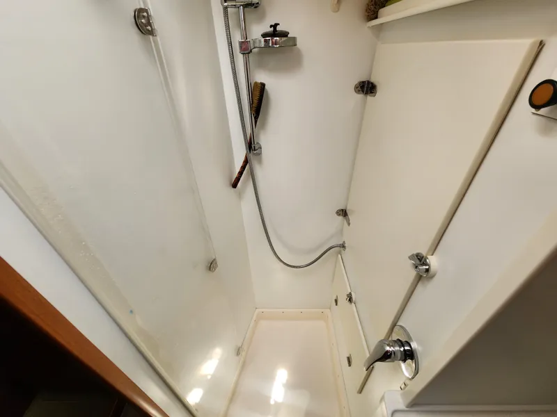 Slide: The Image of Shower area in a 2006 Hallberg-Rassy 48 yacht, featuring modern fixtures and white interior. - 35