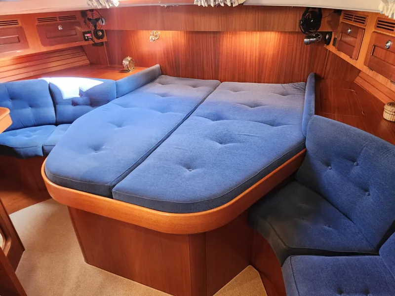 Slide: The Image of Luxurious 2006 Hallberg-Rassy 48 yacht interior with blue upholstery and wooden accents. - 37