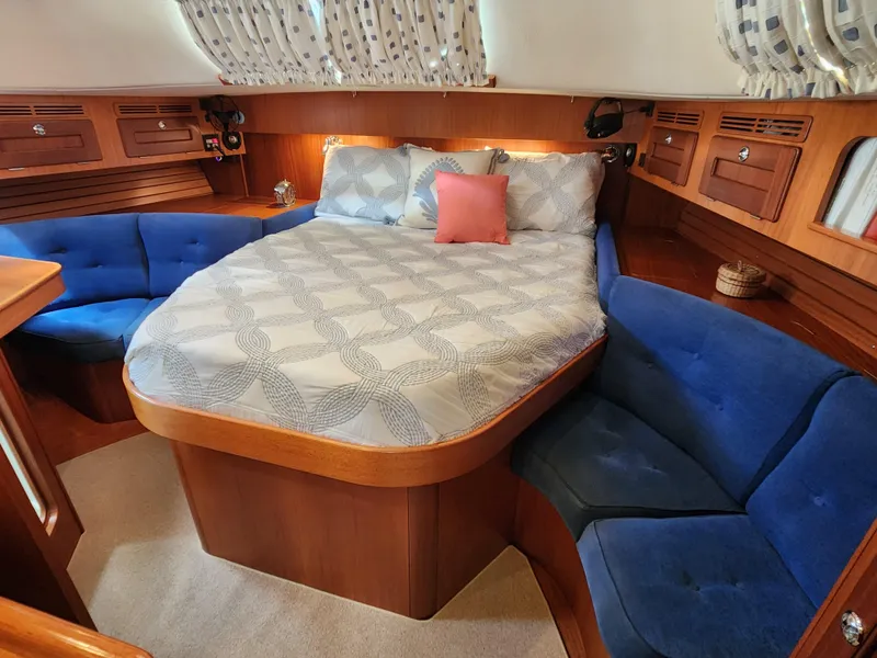 Slide: The Image of Luxurious 2006 Hallberg-Rassy 48 yacht cabin with cozy bed and blue seating. - 38