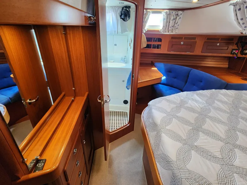 Slide: The Image of Luxurious 2006 Hallberg-Rassy 48 yacht interior with wood finish and cozy seating area. - 39