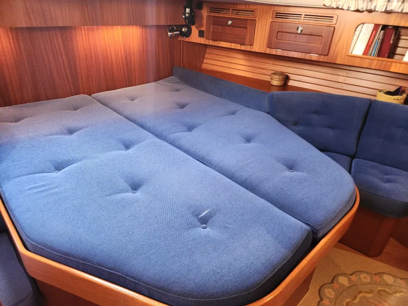 Slide: The Image of Cozy cabin interior of 2006 Hallberg-Rassy 48 yacht with blue cushions and wooden accents. - 41