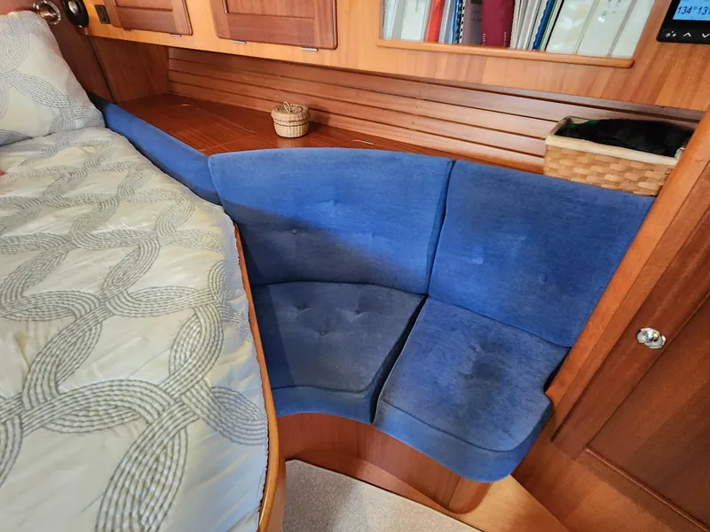 Slide: The Image of Cozy interior of 2006 Hallberg-Rassy 48 yacht with blue seating and wooden accents. - 42