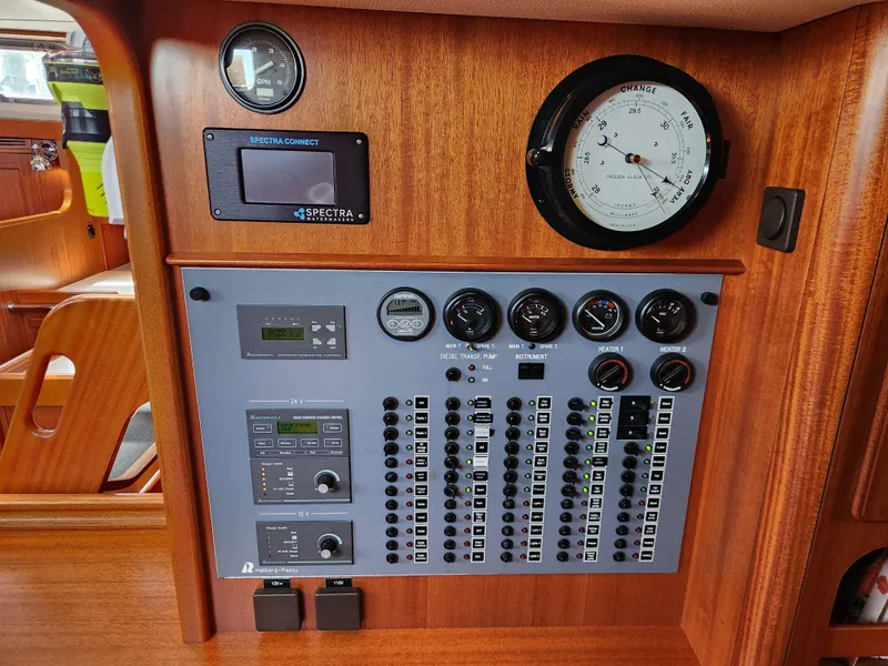 Slide: The Image of Control panel of a 2006 Hallberg-Rassy 48 yacht with gauges and switches. - 43