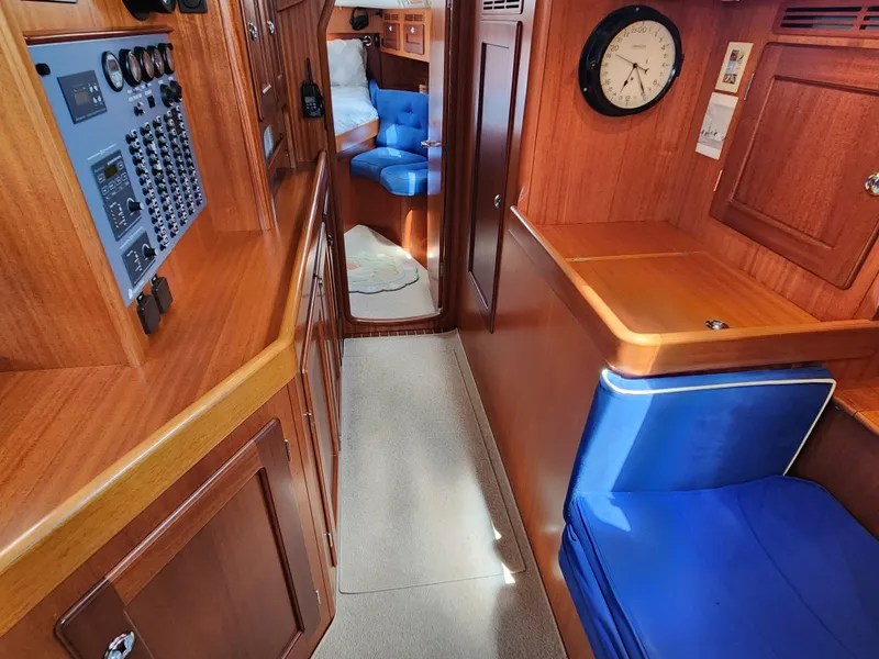 Slide: The Image of Interior of 2006 Hallberg-Rassy 48 yacht with wood paneling and blue seating. - 45