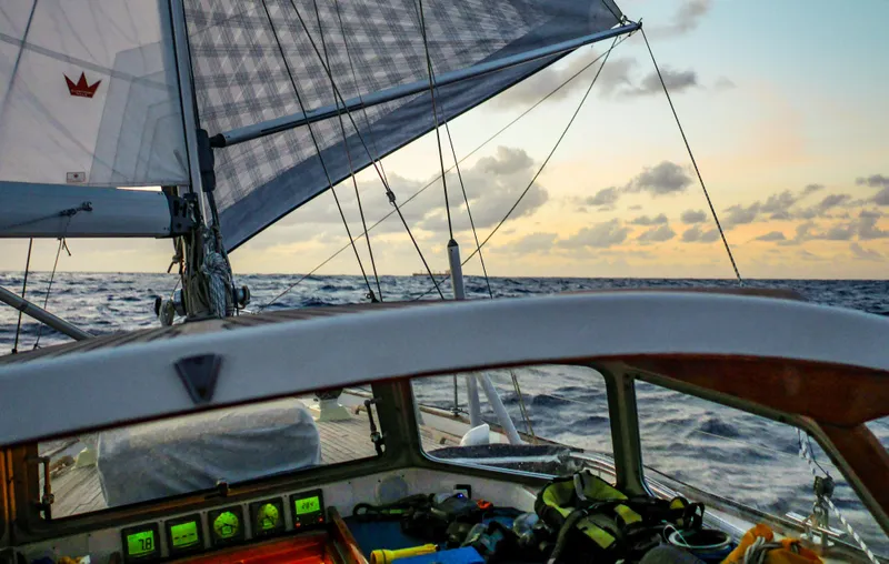 Slide: The Image of Sailing on a 2006 Hallberg-Rassy 48 yacht at sunset, open ocean view. - 8