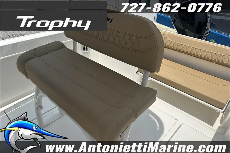 Slide: The Image of 2025 Trophy T24 CC boat interior with tan seating, contact info, and logo. - 15